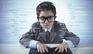 Earnest boy in a suit places hands on keyboard; a translucent field of code fills the foreground